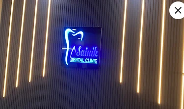 Neon Sainik Dental Clinic sign inside the clinic